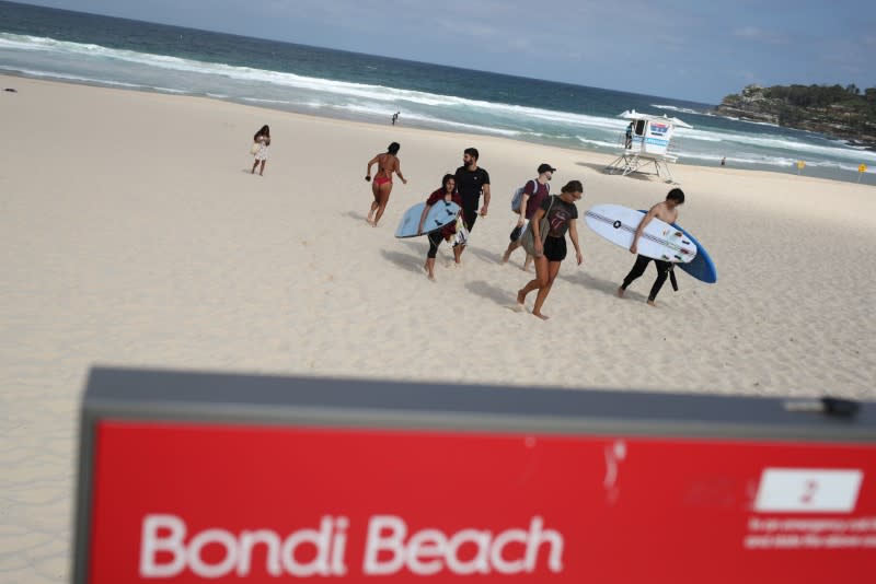 Beachgoers depart Bondi Beach following its closure to prevent the spread of the coronavirus disease (COVID-19) in Sydney
