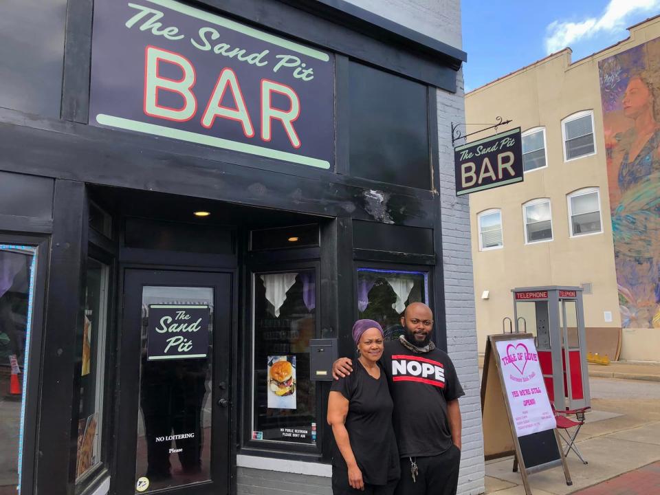Table of Love restaurant owners Toni Goode and Isaiah Walton pose in front of their new storefront on May 7, 2024. It was created as part of a movie set in Hopewell, possibly a Pharrell Williams musical.