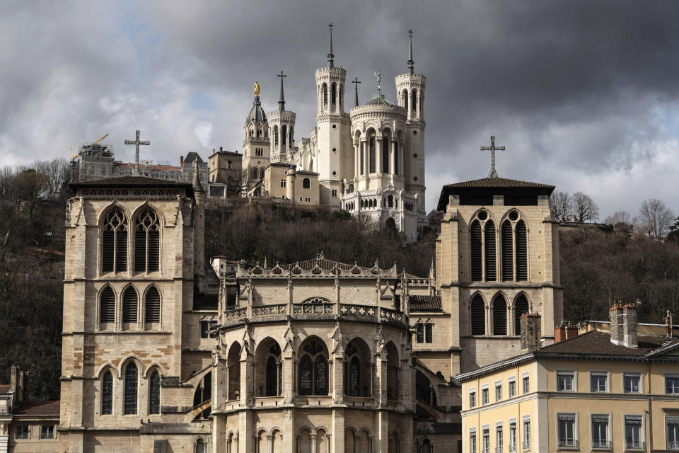 The Saint-Jean Cathedral, foreground, and the Fourviere Basilica, top, are pictured in Lyon, central France, Thursday, March 7, 2019. France's top catholic official Cardinal Philippe Barbarin said he will offer his resignation to Pope Francis, after a court found him guilty of failing to report allegations of sexual abuse of minors by a priest. (AP Photo/Laurent Cipriani)