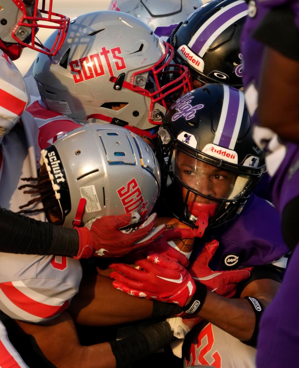 Africentric wide receiver Caleb Anthony is tackled by Walnut Ridge defenders on Friday.