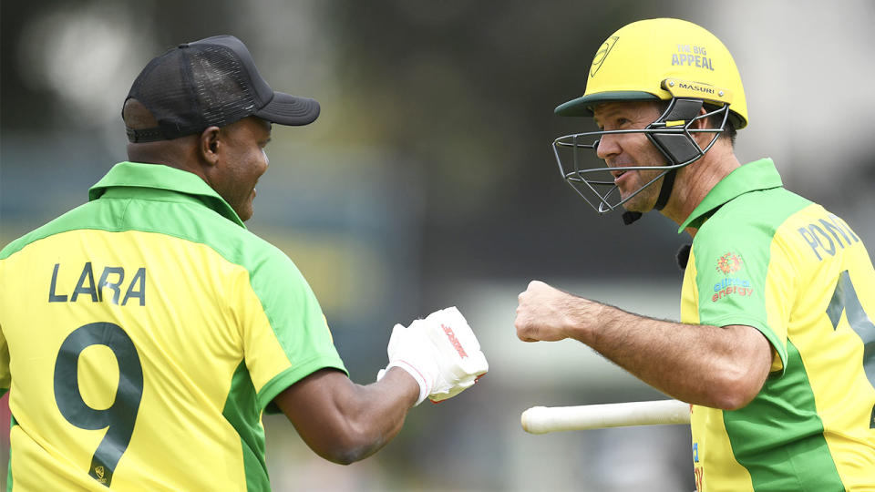 Brian Lara and Ricky Ponting fist pump as they bat.