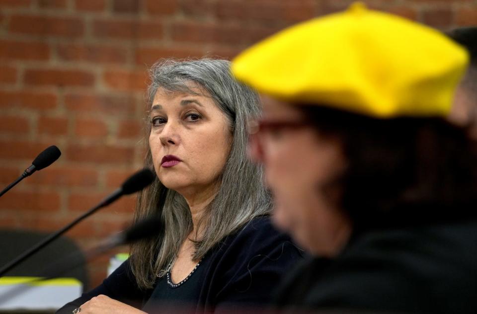 Rep. Jennifer Boylan, D-Barrington, listens as fellow Rep. Camille Vella Wilkinson, D-Warwick, reads her gun bill during Monday's testimony before the House Judiciary Committee.