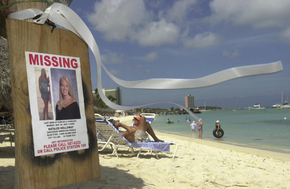 FILE - A sign of Natalee Holloway, an Alabama high school graduate who disappeared while on a graduation trip to Aruba, is seen on Palm Beach, in front of her hotel in Aruba, Friday, June 10, 2005, as a ribbon in her memory blows in the breeze. The government of Peru on Wednesday, May 10, 2023, issued an executive order allowing the temporary extradition to the United States of Joran van der Sloot, the prime suspect in the unsolved 2005 disappearance of Natalee Holloway. (AP Photo/Leslie Mazoch, File)