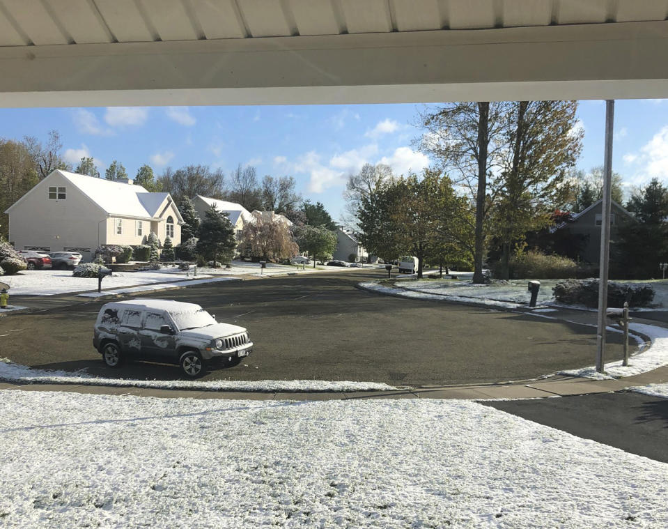 In this photo provided by Robert Beretta, snow accumulates on the grass and vehicles in Monroe, N.Y., Saturday, May 9, 2020. Mother's Day weekend got off to an unseasonably snowy start in areas of the Northeast thanks to the polar vortex. (Robert Beretta via AP)