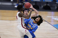 Alabama guard Keon Ellis (14) collides with UCLA guard Tyger Campbell (10) in the first half of a Sweet 16 game in the NCAA men's college basketball tournament at Hinkle Fieldhouse in Indianapolis, Sunday, March 28, 2021. (AP Photo/Michael Conroy)