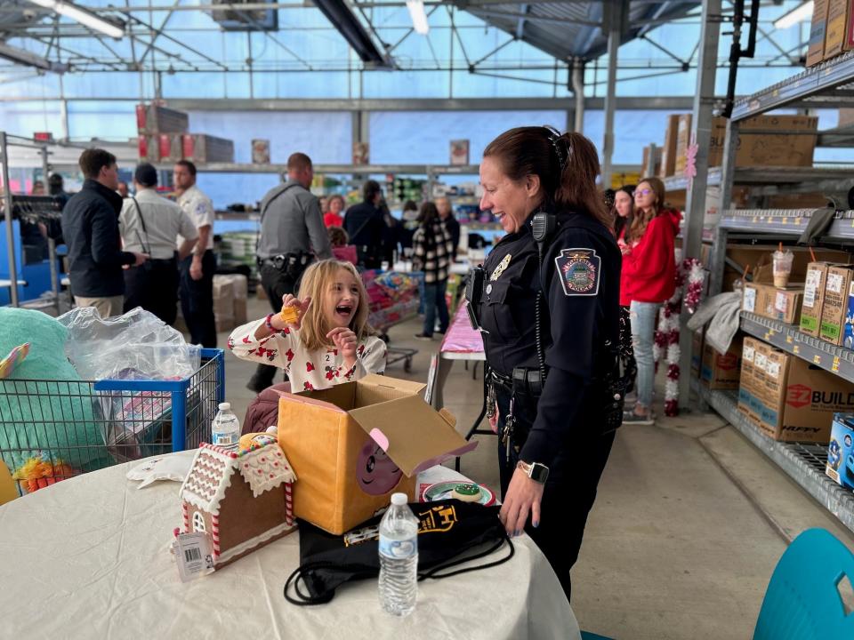 Kennedy Faidley, 8, and Somerset Borough Police Officer C. Sechler enjoy time together exploring the toys at the Somerset County Shop with a Cop event Wednesday morning.