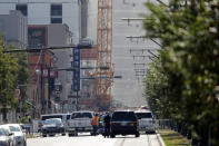 Two large cranes from the Hard Rock Hotel construction collapse come crashing down after being detonated for implosion in New Orleans, Sunday, Oct. 20, 2019. New Orleans officials set off several explosions Sunday intended to topple two cranes that had been looming over the ruins of a partially collapsed hotel. (AP Photo/Gerald Herbert)