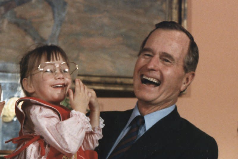 President George H.W. Bush holds Jessica McClure, a Texas toddler whose rescue from an abandoned well in Texas in October 1987 captured national attention, on July 19, 1989, at the White House. Photo courtesy the White House