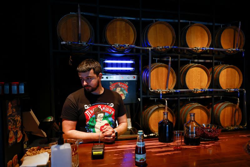 Employee of the Piana Vyshnia (Drunken Cherry) works inside a chain's bar in Kyiv