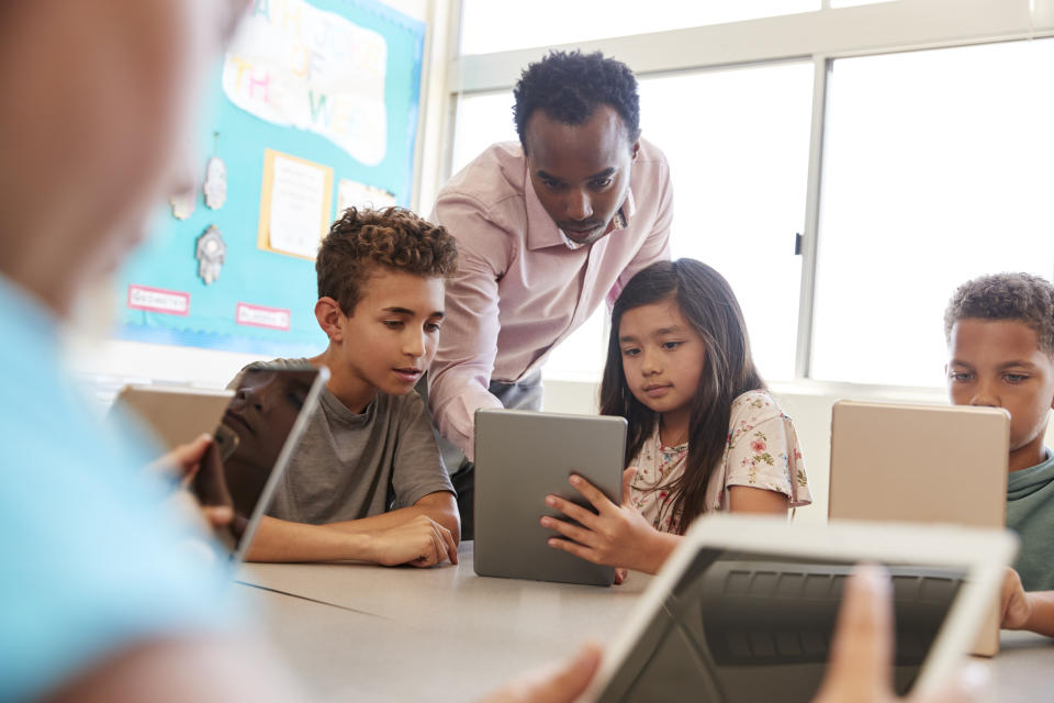 Kids using tablets in a classroom.