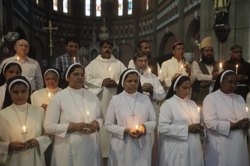 Pakistani citizens from different faiths light candles at a vigil for the victims of bomb explosions in churches and hotels in Sri Lanka, in Lahore, Pakistan, Monday April 22, 2019. (AP Photo/K.M. Chaudary)