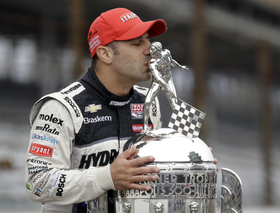 FILE - Tony Kanaan, of Brazil, kisses the Borg-Warner Trophy as he poses during the traditional photo session for the winner of the Indianapolis 500 auto race at the Indianapolis Motor Speedway in Indianapolis, in this Monday, May 27, 2013, file photo. Superstar Racing Experience was conceptualized as a series for former greats who still had the skills and desire to compete and square off in identically prepared cars at six of America’s classic short tracks. Ray Evernham and Tony Stewart took great care in extending invites to the made-for-TV league they had co-created. They thoughtfully pulled in a a dozen of the most iconic names in modern day motorsports. (AP Photo/Michael Conroy, File)