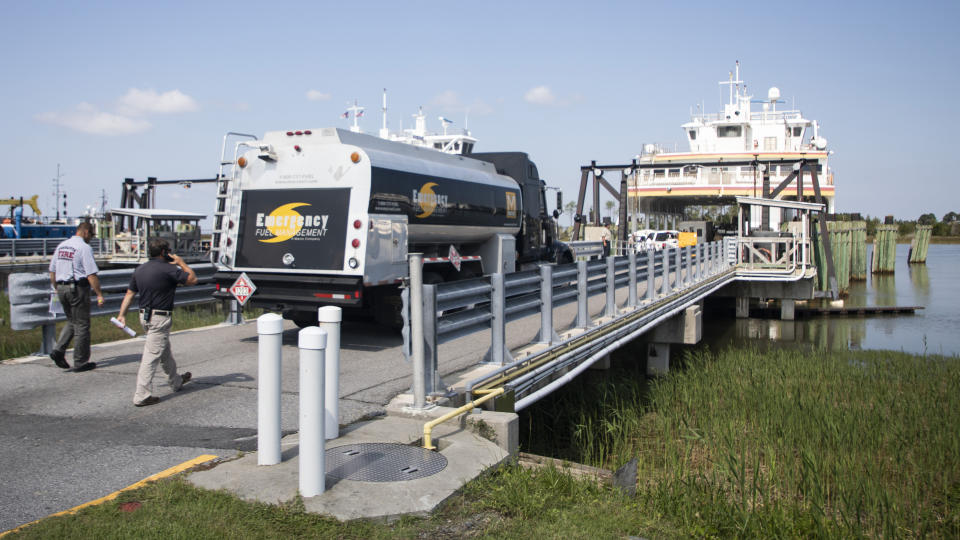 A fuel truck boards the Swan Quarter Ferry in Swan Quarter, N.C. with other emergency response vehicles, generators and supplies headed to Ocracoke on Saturday, Sept. 7, 2019. Officials in North Carolina say search-and-rescue teams are going door to door to check on people who may be injured or in need of assistance after Hurricane Dorian swamped Ocracoke Island with floodwaters. (Julia Wall/The News & Observer via AP)