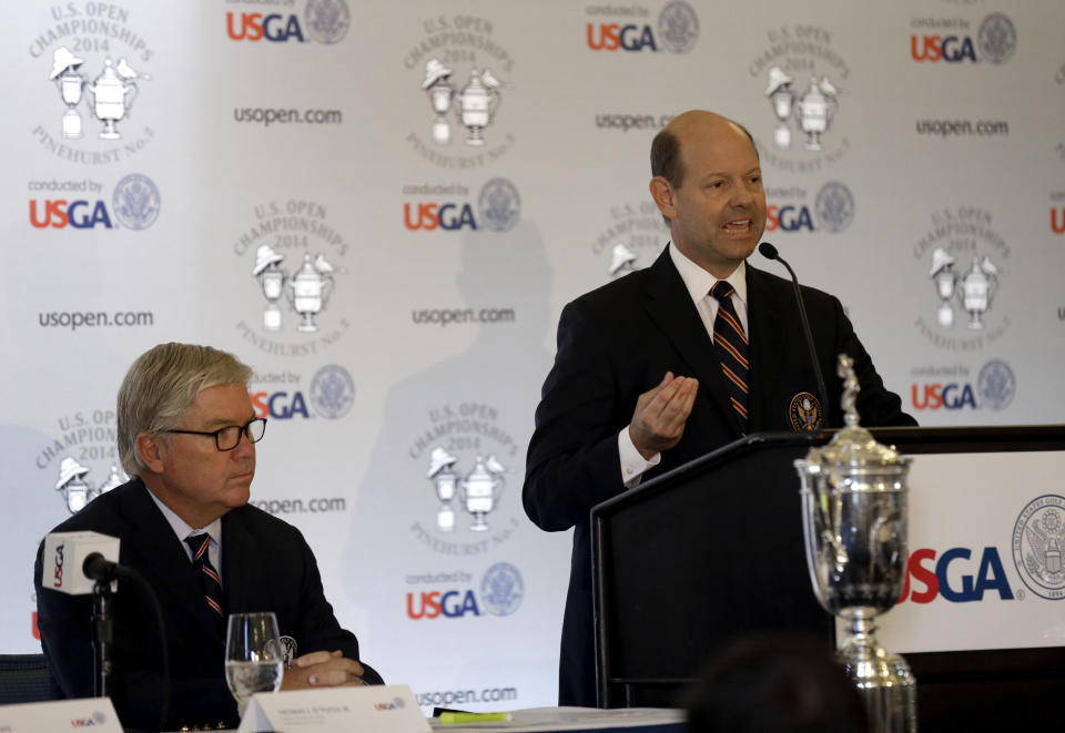 Mike Davis, right, Executive Director of the United States Golf Association, speaks as USGA President Thomas J. O'Toole, left, listens at Pinehurst Resort & Country Club during media day for the upcoming back-to-back U.S. Open and U.S. Women's Open golf championships to be held this June in Pinehurst, N.C., Monday, April 21, 2014. (AP Photo/Gerry Broome)