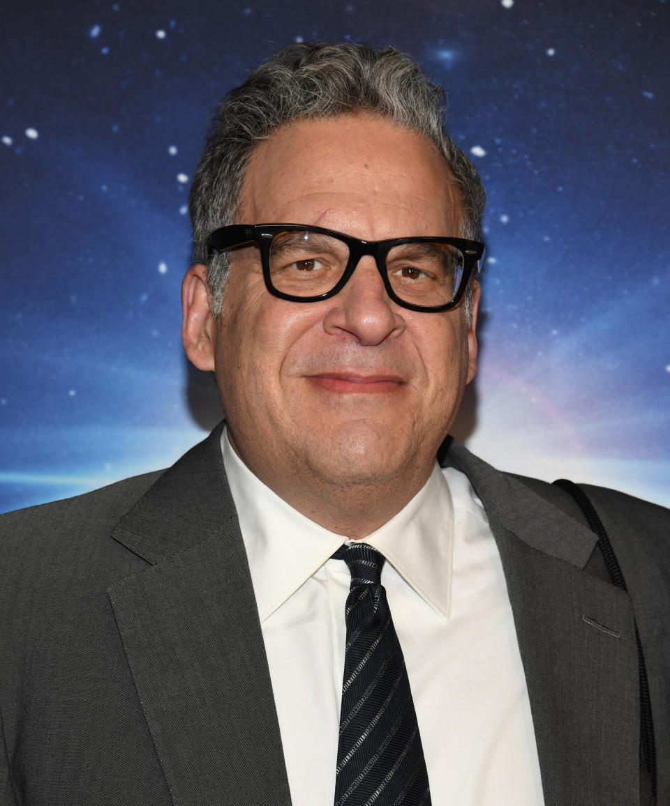 Photo of Jeff Garlin in thick black glasses and a gray suit