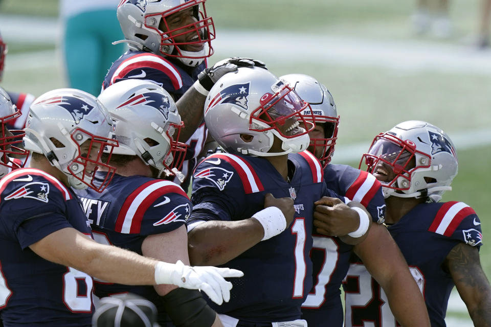 New England Patriots quarterback Cam Newton (1) celebrates his rushing touchdown against the Miami Dolphins with teammates in the first half of an NFL football game, Sunday, Sept. 13, 2020, in Foxborough, Mass. (AP Photo/Steven Senne)