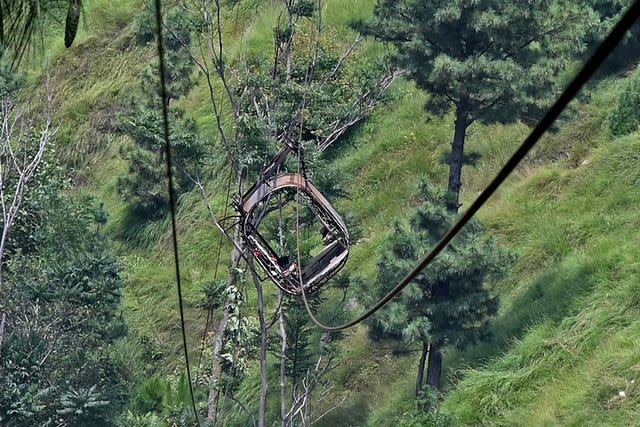 <p>FAROOQ NAEEM/AFP via Getty</p> Cable car dangling over ravine in Khyber Pakhtunkhwa province