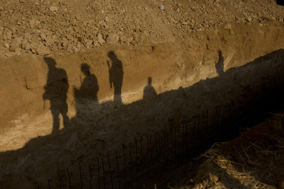 U.S. forces visit a trench during a joint patrol with the Tal Abyad Military Council in the safe zone near the Turkish border in Syria, Friday, Sept. 6, 2019. Once part of the sprawling territories controlled by the Islamic State group, the villages are under threat of an attack from Turkey which considers their liberators, the U.S-backed Syrian Kurdish-led forces, terrorists.T o forestall violence between its two allies along the border it has helped clear of IS militants, Washington has upped its involvement in this part of Syria.. (AP Photo/Maya Alleruzzo)