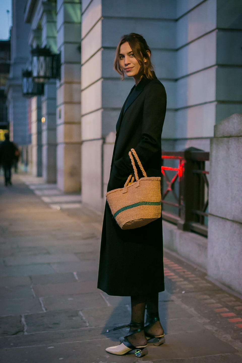 Alexa Chung looks lovely in a low-key overcoat and a very Jane Birkin-esque basket bag.