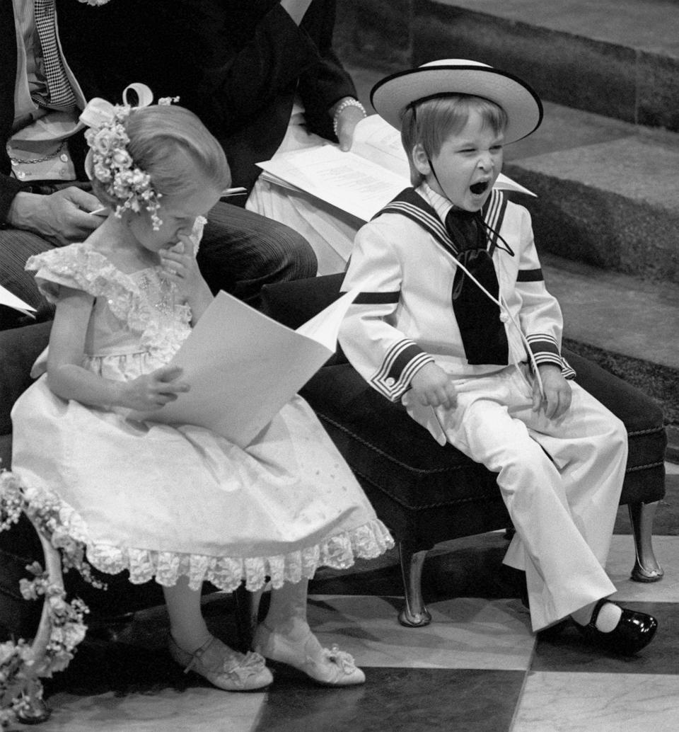A yawn from Prince William, the 3 year-old son of the Prince and Princess of Wales, during the wedding ceremony of Sarah Ferguson and the Duke of York at Westminster Abbey. Seated next to the young Prince is his cousin, 6 year-old Laura Fellowes.   (Photo by PA Images via Getty Images)