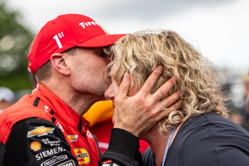Will Power kisses his wife, Liz, in victory lane after winning the NTT IndyCar Series XPEL Grand Prix on Sunday, June 9, 2024, at Road America near Elkhart Lake, Wisconsin.