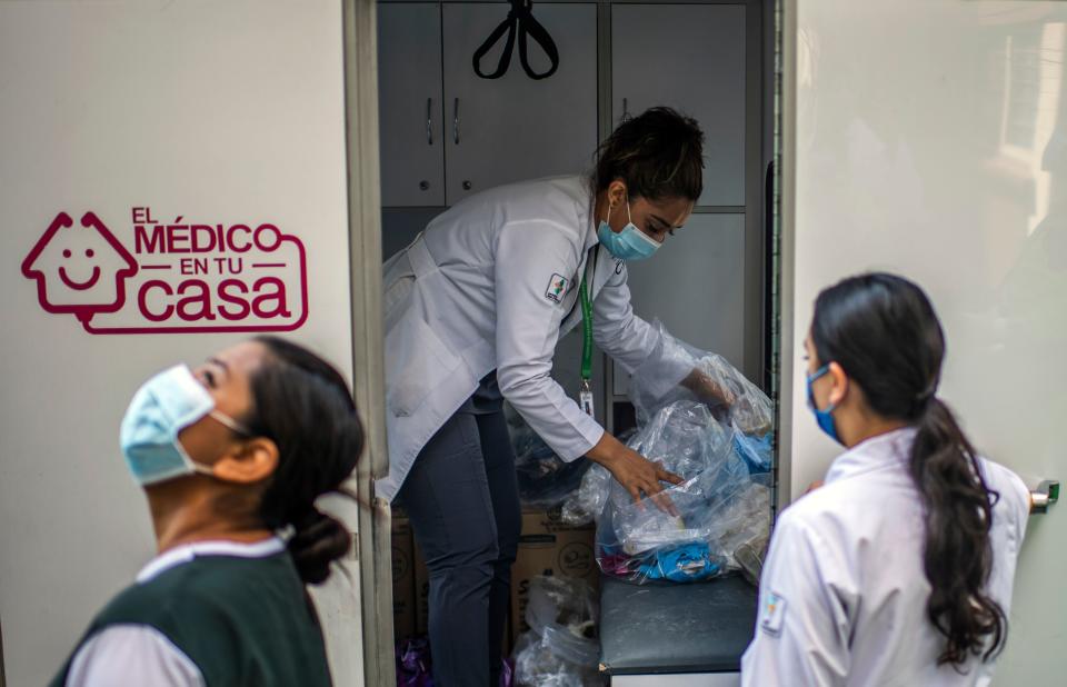 A health brigade gets ready while on door-to-door visits to carry out COVID-19 tests in Mexico City, on June 16, 2020, amid the new coronavirus pandemic. (Photo by PEDRO PARDO / AFP) (Photo by PEDRO PARDO/AFP via Getty Images)