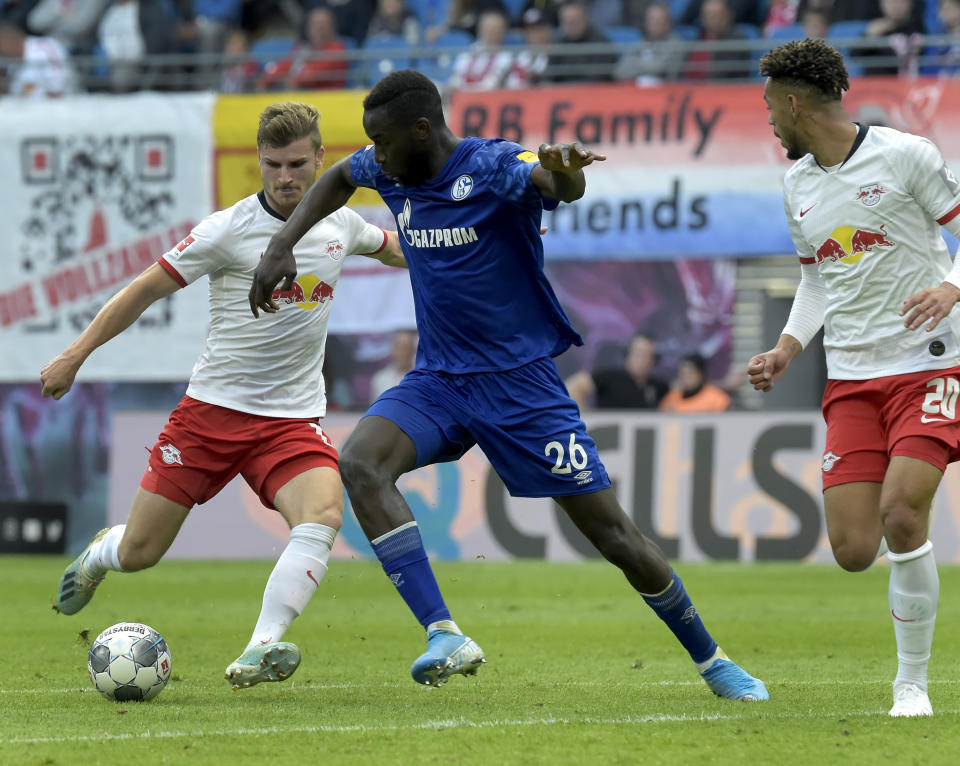 Leipzig's Timo Werner, left, and Schalke's Salif Sane, right, challenge for the ball during the German Bundesliga soccer match between RB Leipzig and FC Schalke 04 in Leipzig, Germany, Saturday, Sept. 28, 2019. (AP Photo/Jens Meyer)