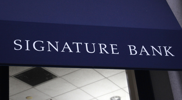 The logo for Signature Bank is displayed over the entrance to a building.