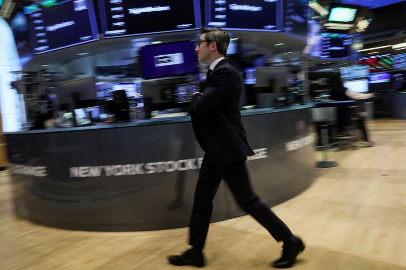 FILE PHOTO: Traders work on the floor of the NYSE in New York