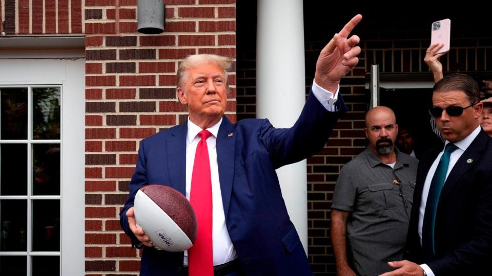 PHOTO: In this Sept. 9, 2023, file photo, former President Donald Trump holds a football before throwing it to the crowd at Iowa State University in Ames, Iowa.  (Charlie Neibergall/AP, FILE)
