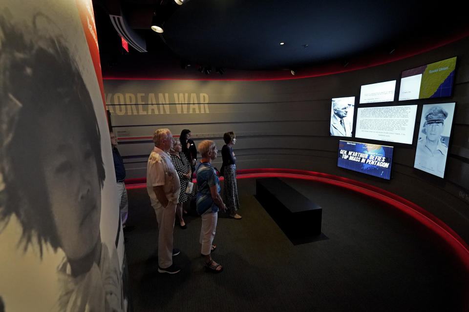 People view an exhibit about the Korean War during a tour of the Harry S. Truman Presidential Library and Museum Wednesday, June 9, 2021, in Independence, Mo. The facility will reopen July 2 after a nearly $30 million renovation project. (AP Photo/Charlie Riedel)