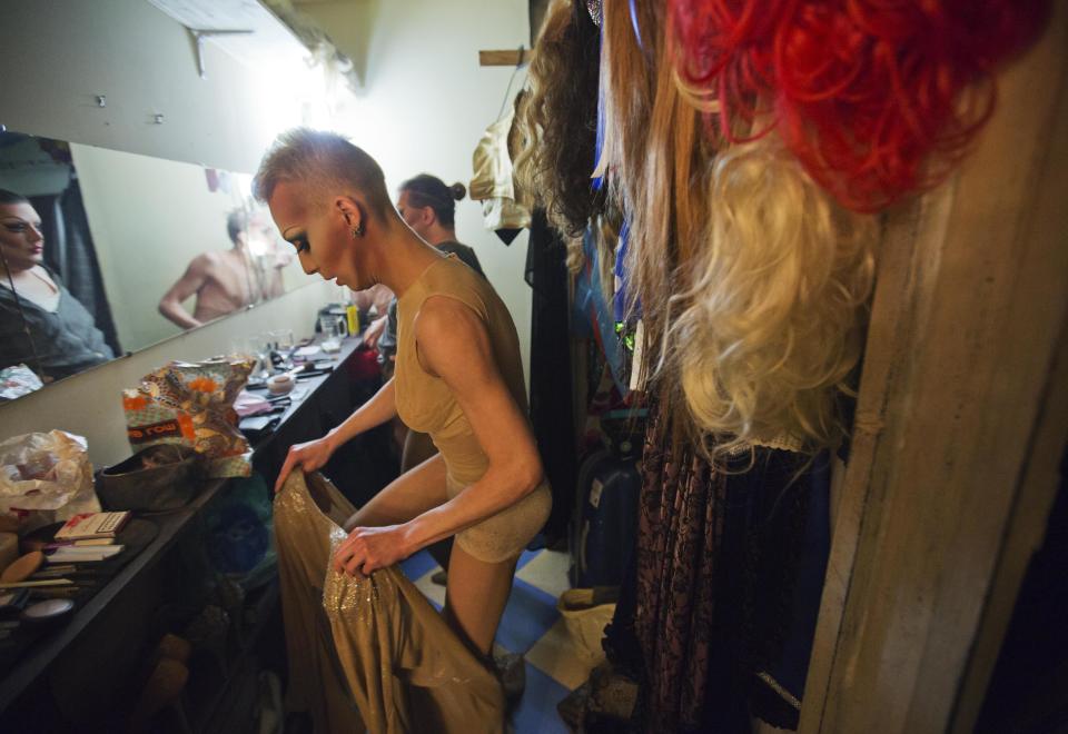 In this photo taken Saturday, Feb. 8, 2014, Kira, who would only give his stage name, gets ready backstage before a performance at the Mayak cabaret, the most reputable gay club in Sochi, Russia, host to 2014 Winter Olympics. Russia adopted a law last year, prohibiting vaguely defined propaganda of non-traditional sexual relations and pedophilia. The legislation makes it illegal to disseminate information to children even if it merely shows that gay people are just like everybody else. At Mayak, packed on Saturday night, gay men and women steered away from discussing the law, preferring to enjoy life, closeted as it is. About a hundred people were chatting at the bar, sitting in armchairs or dancing. Couples were sharing kisses. Everyone was waiting for the club's specialty: a drag show. At 1.30 a.m. on Sunday, the music stopped and the show began. (AP Photo/David Goldman)