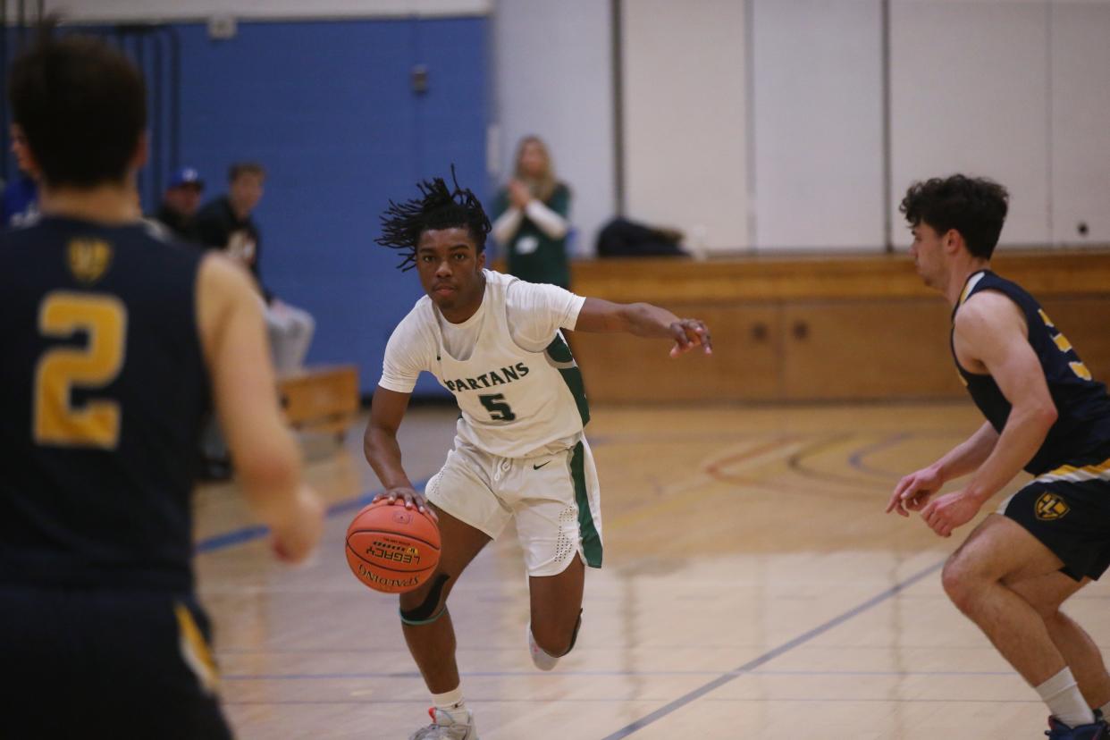 Spackenkill's Nasir Snell drives up court during the MHAL boys basketball final versus Lourdes on February 23, 2023. 