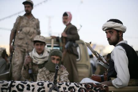 Houthi fighters patrol a road where followers ofthe Houthi movement are demonstrating to show support to the Houthi movement in Sanaa January 23, 2015. REUTERS/Khaled Abdullah