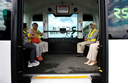 Local residents are seen inside Robot Shuttle, a driver-less, self driving bus, developed by Japan's internet commerce and mobile games provider DeNA Co., during an experimental trial with a self-driving bus in a community in Nishikata town, Tochigi Prefecture, Japan September 8, 2017. REUTERS/Issei Kato