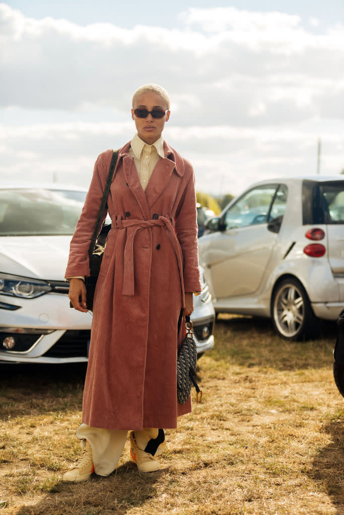 Model Adwoa Aboah sports a belted corduroy coat, a Dior saddle bag and Off-White Nike sneakers after the Dior show during Paris Fashion Week on Sept. 24. (Photo: Getty Images)