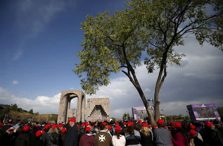 People attend a canonisation ceremony for the victims of mass killings of Armenians by Ottoman Turks at the open-air altar of Armenia's main cathedral in Echmiadzin April 23, 2015. REUTERS/David Mdzinarishvili