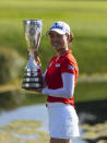 Australia's Minjee Lee holds the trophy as she poses for photographers after winning the Evian Championship women's golf tournament in Evian, eastern France, Sunday, July 25, 2021. (AP Photo)