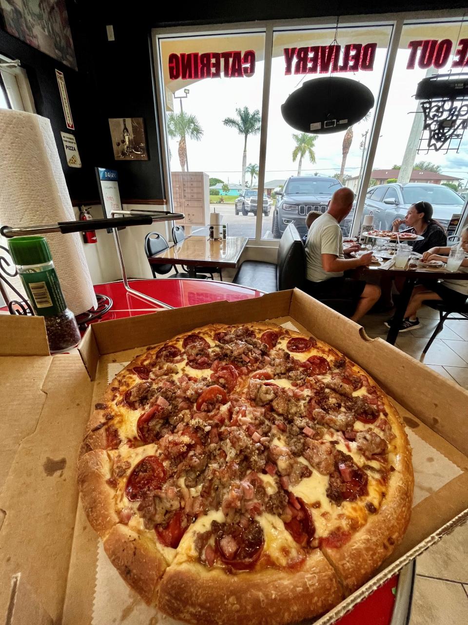 A meat lovers pizza with (optional) brown sugar sprinkled in from Gino's Pizza in Cape Coral