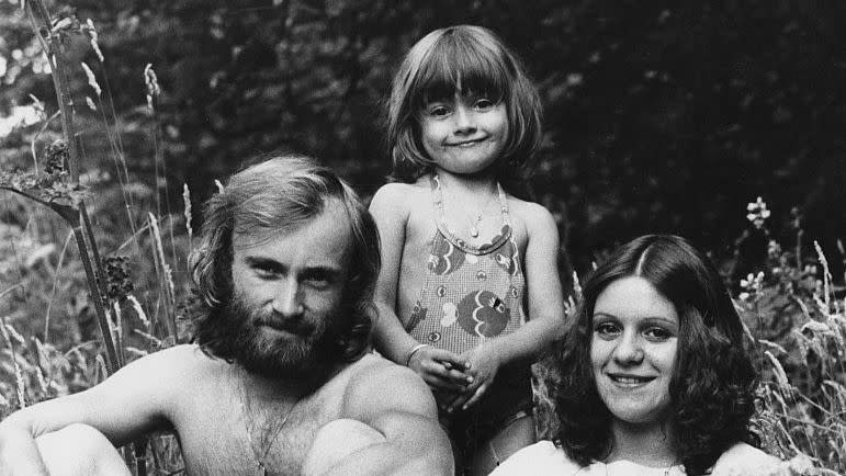 phil collins posing with his adopted daughter joely and his ex wife andrea bertorelli in a grassy field