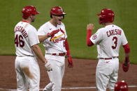 St. Louis Cardinals' Nolan Arenado is congratulated by teammates Paul Goldschmidt (46) and Dylan Carlson (3) after hitting a three-run home run during the third inning of a baseball game against the New York Mets Monday, May 3, 2021, in St. Louis. (AP Photo/Jeff Roberson)
