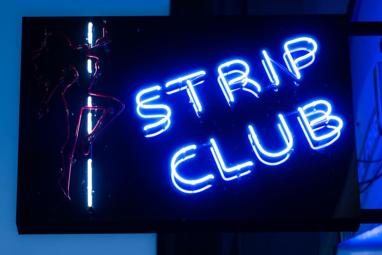 girls strip club blue neon sign and woman silhouette