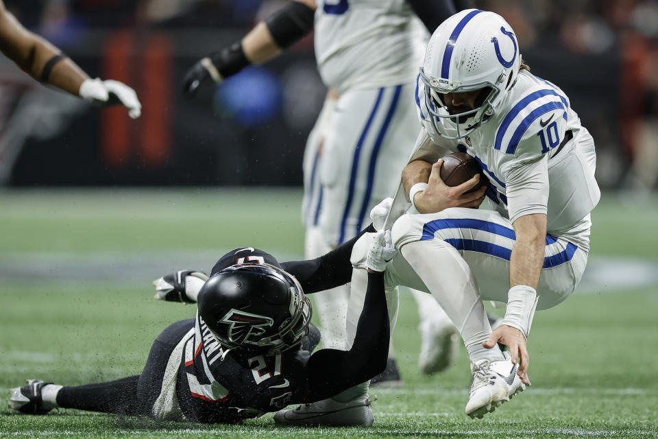 Indianapolis Colts quarterback Gardner Minshew (10) is sacked by Atlanta Falcons safety Richie Grant (27) during the second half of an NFL football game, Sunday, Dec. 24, 2023, in Atlanta. (AP Photo/Alex Slitz)