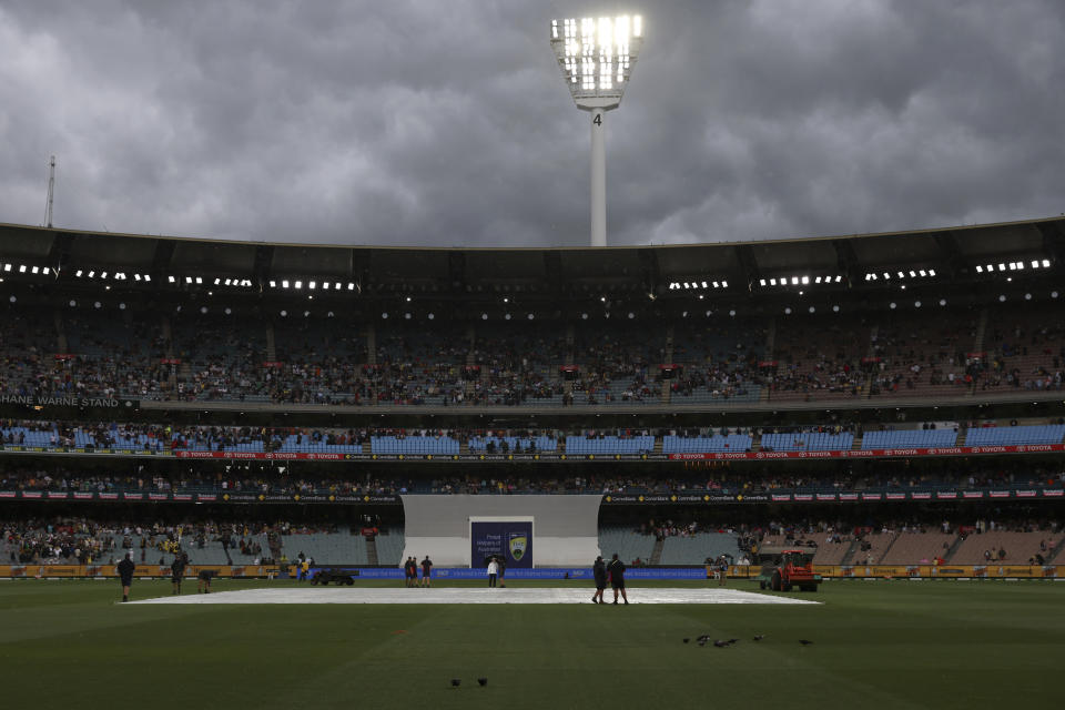 Covers are placed on the wicket as weather interrupts play between Australia and Pakistan during their cricket test match in Melbourne, Tuesday, Dec. 26, 2023. (AP Photo/Asanka Brendon Ratnayake)