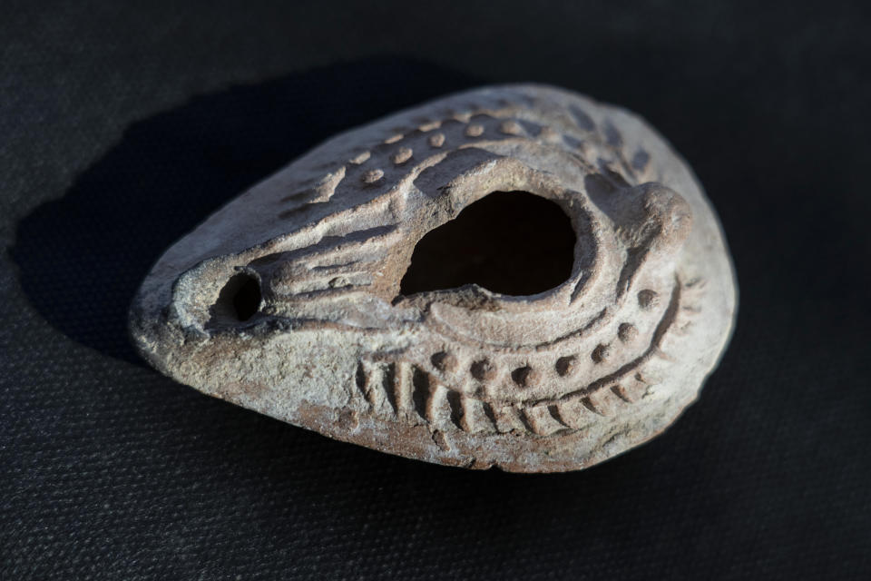 An artifact is displayed from a 1,200-year-old rural estate discovered during excavations by the Israel Antiquities Authority during expansion of the town of Rahat, Israel, Tuesday, Aug. 23, 2022. Located in Israel's south near the Bedouin town of Rahat, the building dates back back to the early Islamic period in the 8th or 9th centuries. (AP Photo/Tsafrir Abayov)