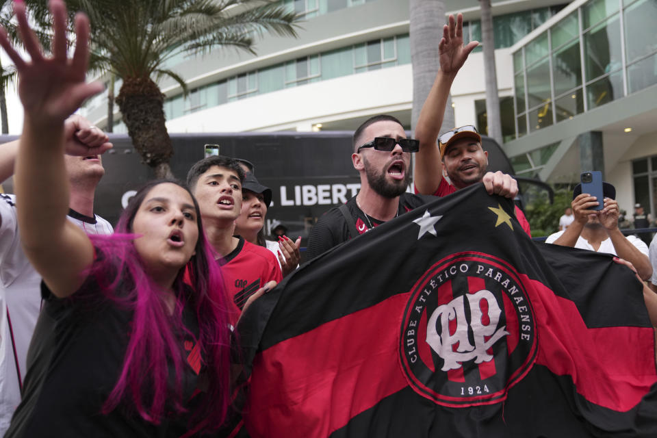 Fans of Brazil´s Atletico Paranaense cheer as their team arrives to the Sheraton hotel for an upcoming soccer final match of the Copa Libertadores in Guayaquil, Ecuador, Wednesday, Oct. 26, 2022. Atletico Paranaense will face Brazil´s Flamengo for the Cup. (AP Photo/Dolores Ochoa)