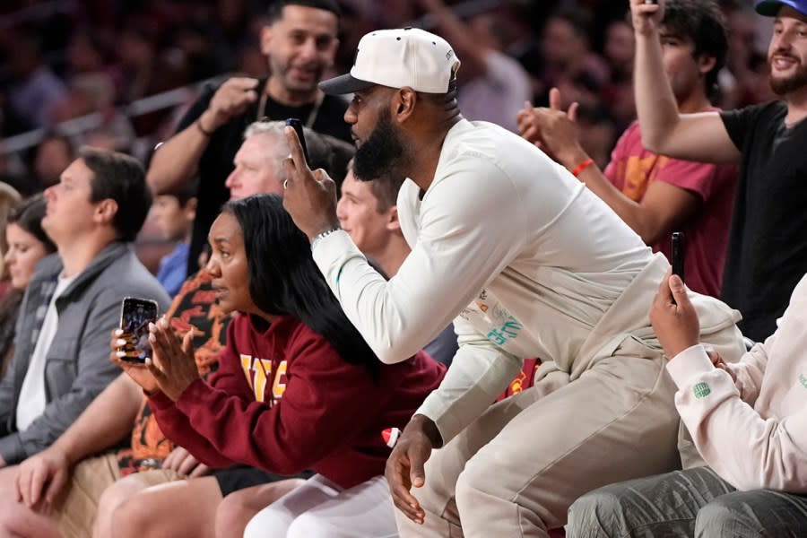 LeBron James watches his son, Southern California guard Bronny James, play during the first half of an NCAA college basketball game against Long Beach State Sunday, Dec. 10, 2023, in Los Angeles. (AP Photo/Mark J. Terrill)