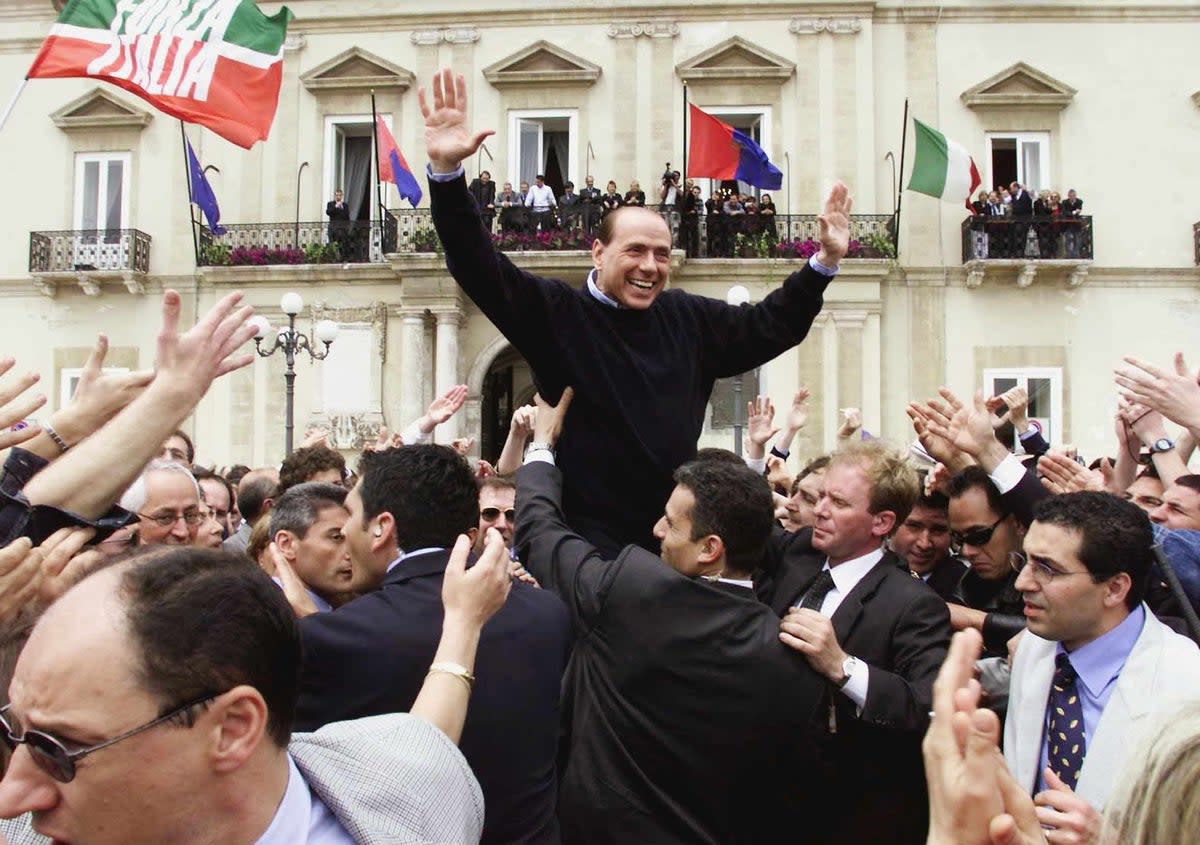 Silvio Berlusconi is carried by his supporters during an election rally in Taranto on Saturday 5 May 2001 (epa)