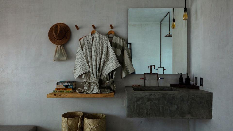 Drift Hotel in San Jose del Cabo's bathroom detail of minimal design and natural textures like wood, woven baskets and concrete