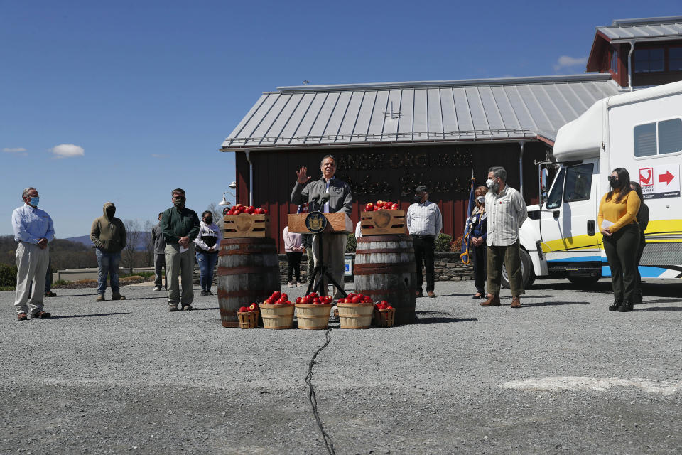 FILE — In this April 13, 2021 file photo, New York Gov. Andrew Cuomo, center, speaks during an event announcing mobile unit vaccination sites for farmworkers and other agribusinesses in New York, at the Angry Orchard Cider House, in Walden, N.Y. The event was closed to the press, except for pooled photography. Cuomo hasn’t held an in-person press conference since December, when he switched to interacting the the media only via telephone and Zoom conference calls, saying it was a needed COVID-19 safety precaution. (Shannon Stapleton/Pool Photo via AP, FIle)